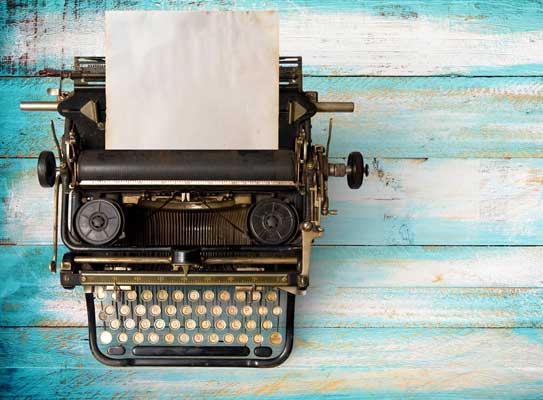 vintage typewriter on a wooden table that was painted blue