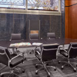 long conference table with comfortable leather chairs