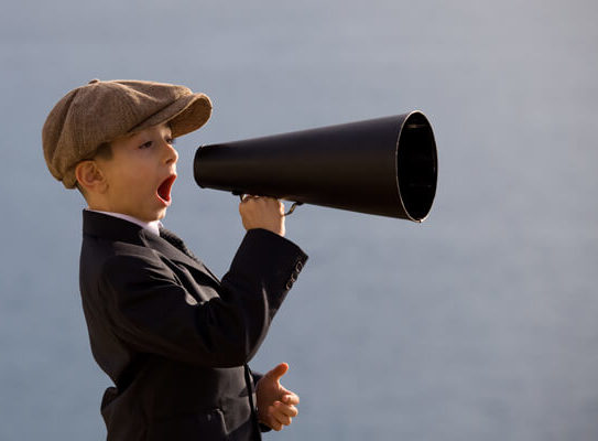 young boy holding a megaphone