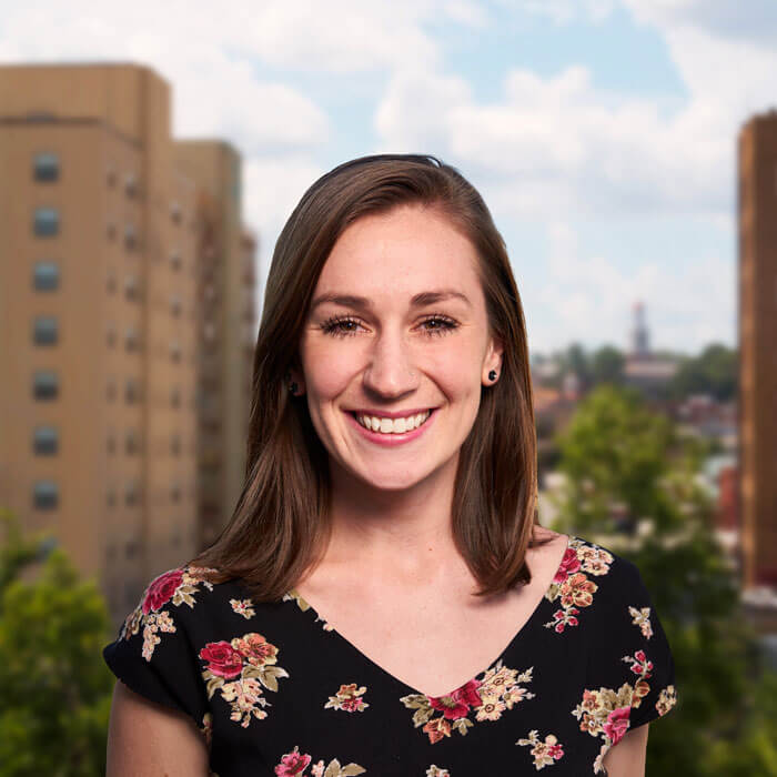 Laura Nielson smiling and standing with Macon's skyline in the background