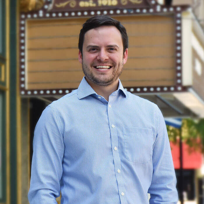Nick Rios smiling and standing in front of Capitol Theatre