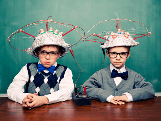 2 young boys in tinfoil hats connected with electrical wiring