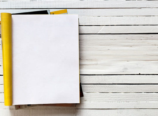 blank notebook on a white wooden background