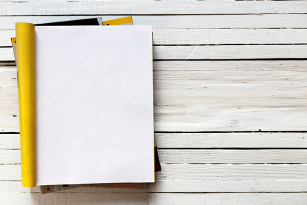 blank notebook on a white wooden background