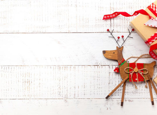 christmas reindeer decorations on a white wooden background