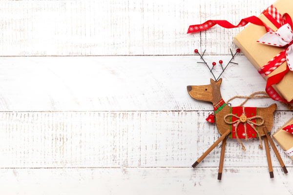 christmas reindeer decorations on a white wooden background