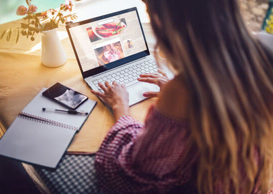 young woman uses laptop for reasearch