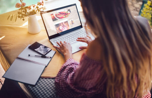 young woman uses laptop for reasearch