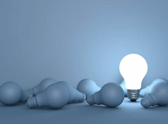 lightbulb turned on in a group of lightbulbs turned off