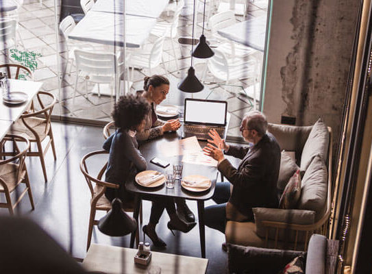 3 business partners having a meeting in a nice restaurant