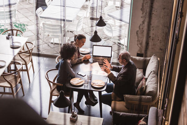 3 business partners having a meeting in a nice restaurant