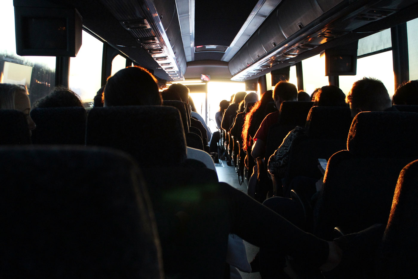 The inside of a city bus that has every seat filled