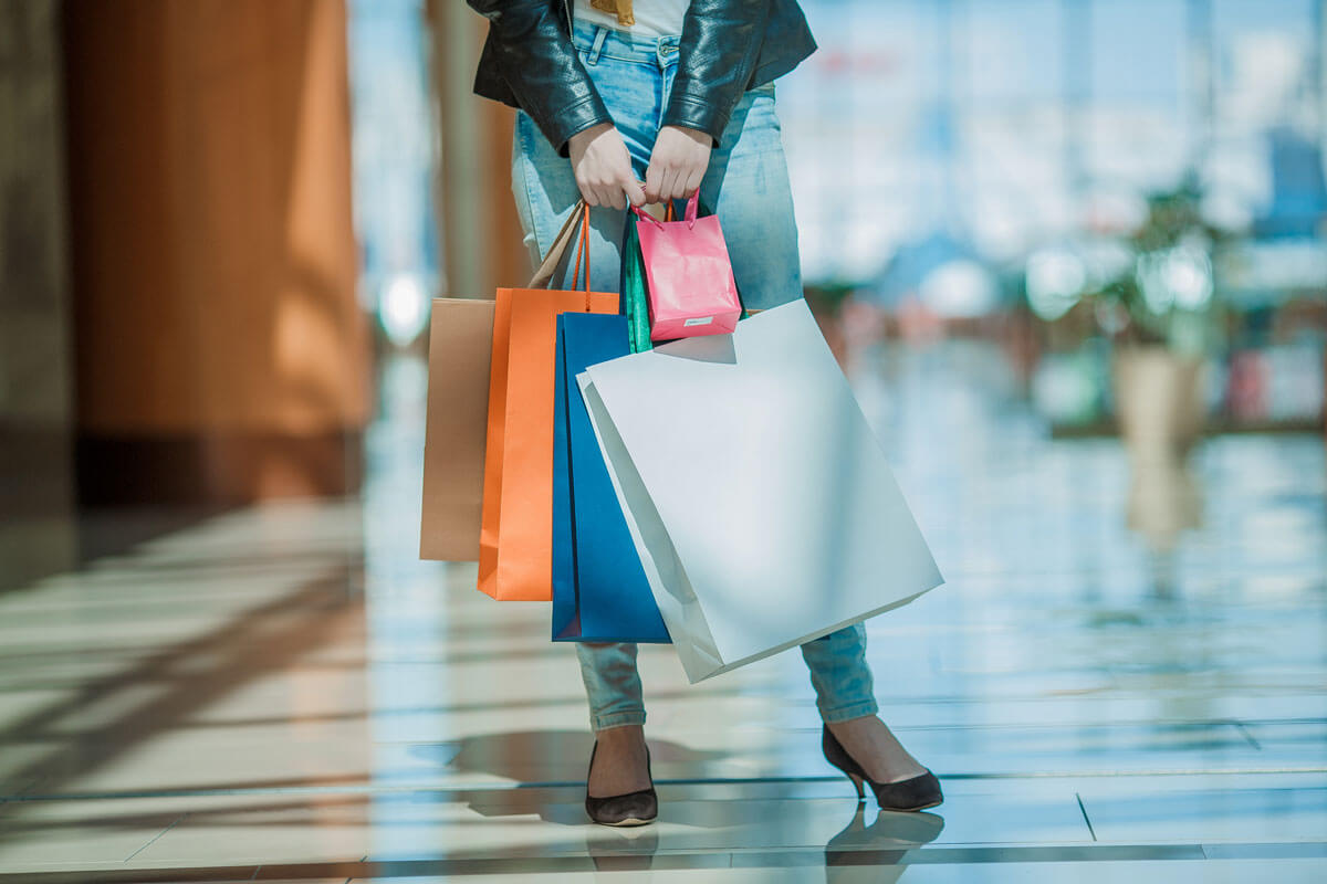 young woman holding several shopping bags