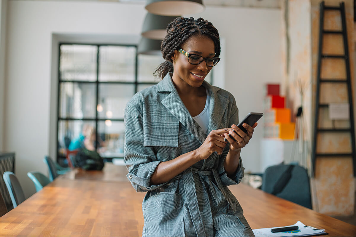 Young woman holding phone to check social media