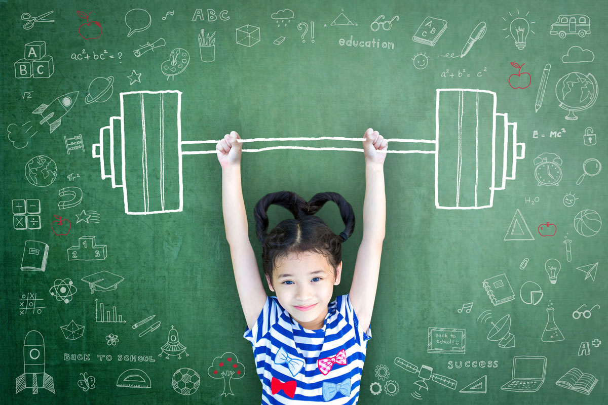 a young girl holds up a barbell