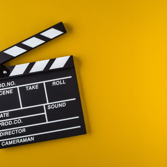 A clapperboard is a device used in filmmaking and video production to assist in synchronizing of picture and sound, and to designate and mark the various scenes and takes as they are filmed and audio-recorded.
