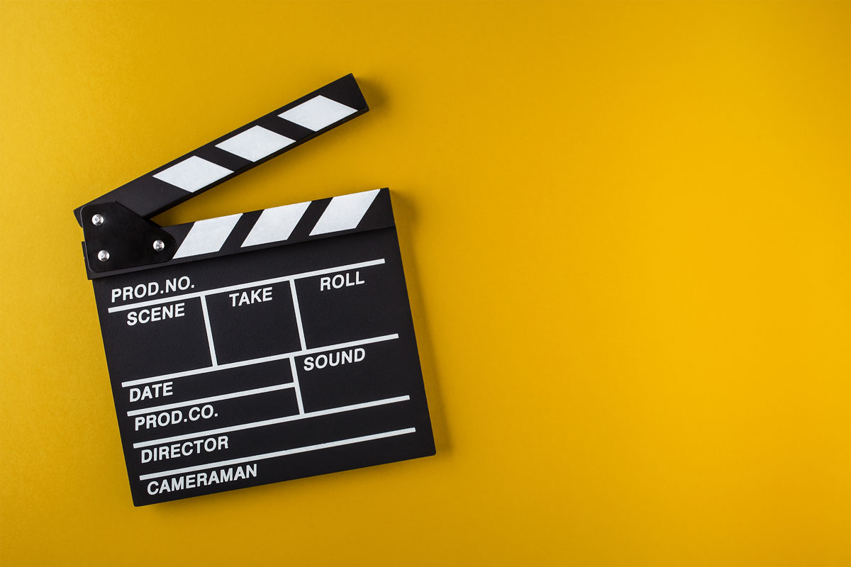 A clapperboard is a device used in filmmaking and video production to assist in synchronizing of picture and sound, and to designate and mark the various scenes and takes as they are filmed and audio-recorded.