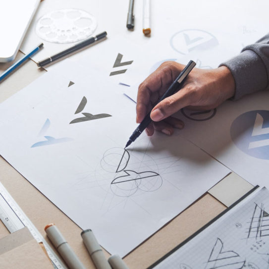 a designer sketching logos