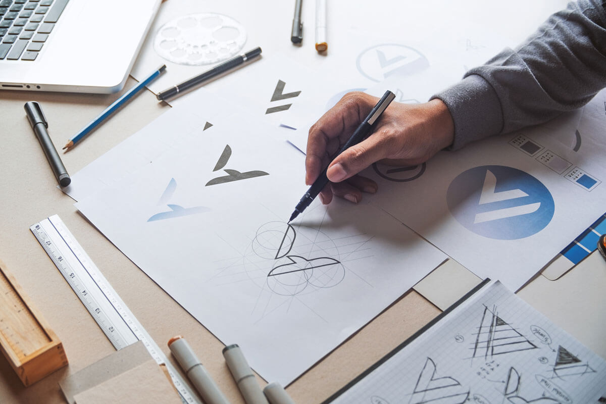 a designer sketching logos