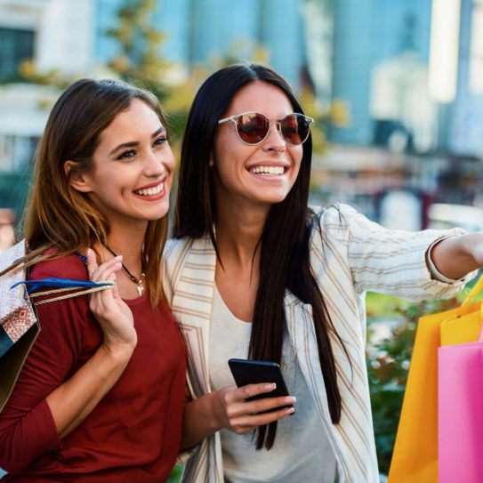 two happy smiling female shoppers