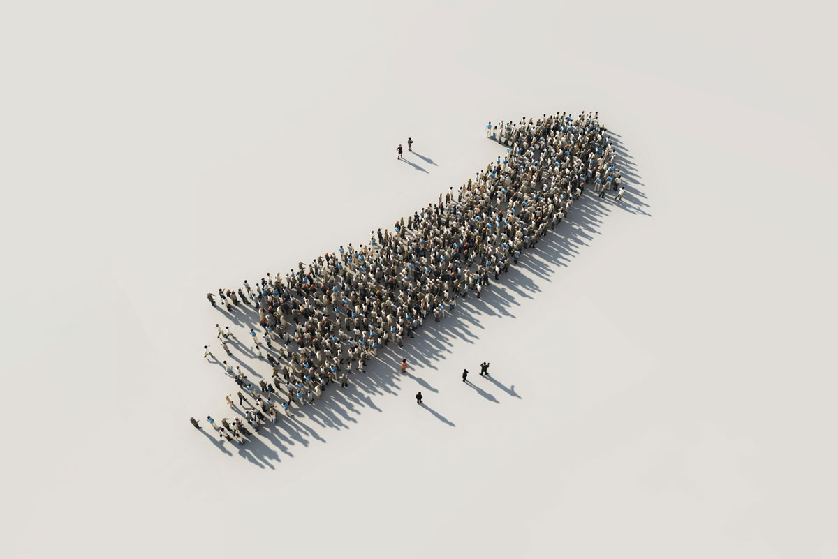 a large group of people standing in the formation of an upward pointing arrow