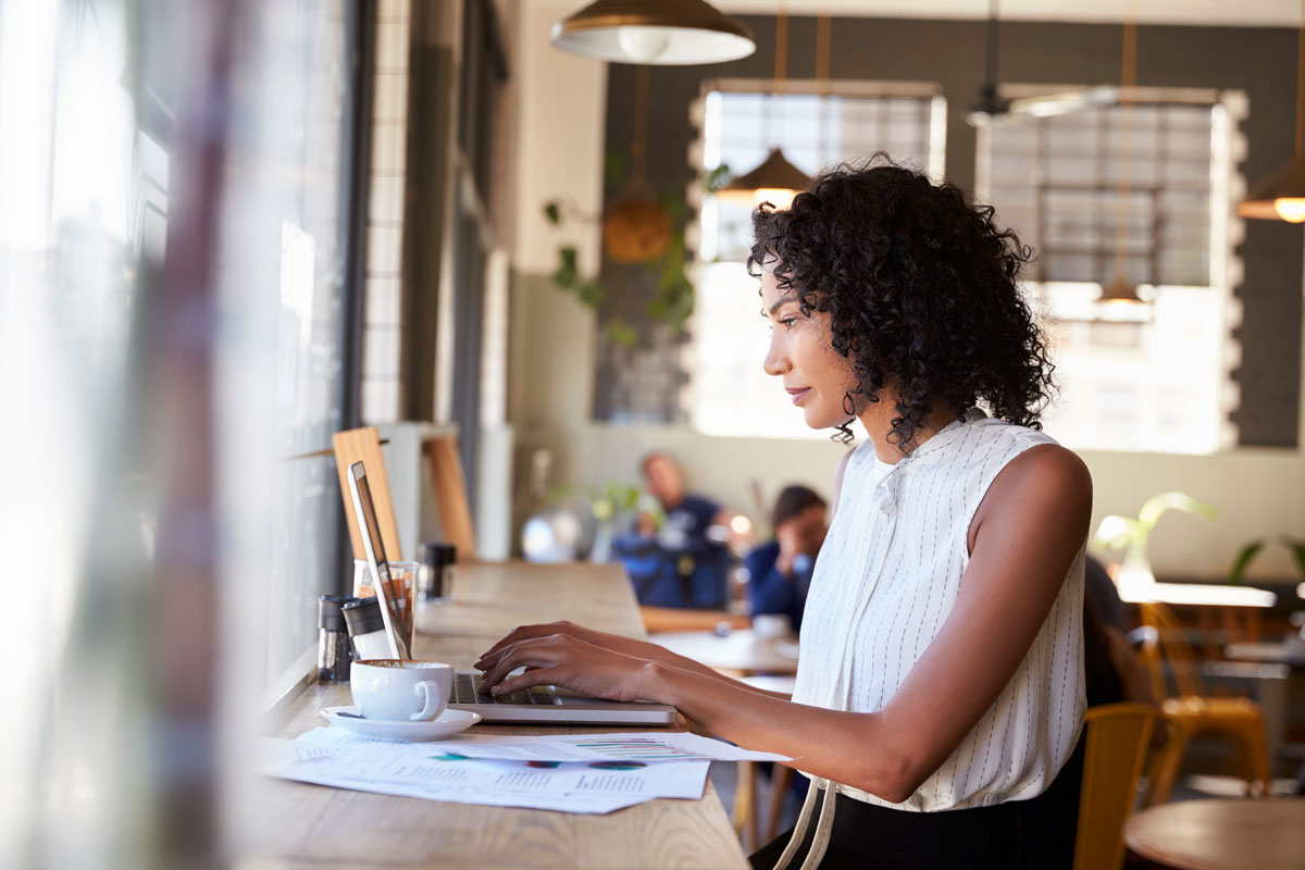 a young business woman uses her laptop computer