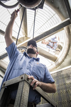 HVAC worker servicing a heat pump