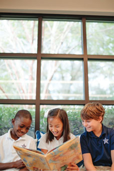 elementary school students reading in a library