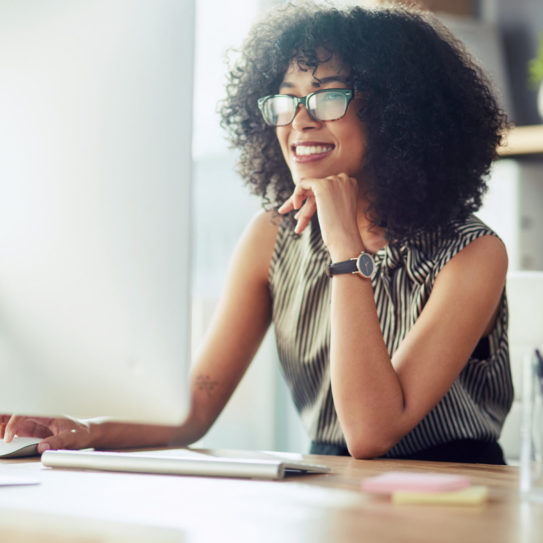 Shot of a young businesswoman using a computer in a modern office