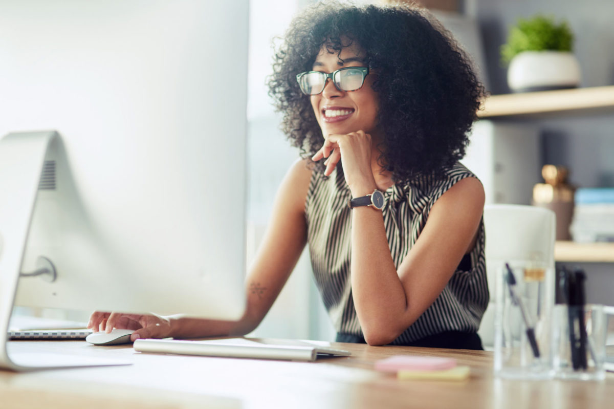 Shot of a young businesswoman using a computer in a modern office