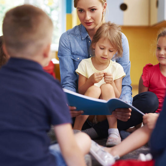 a group of young children reading