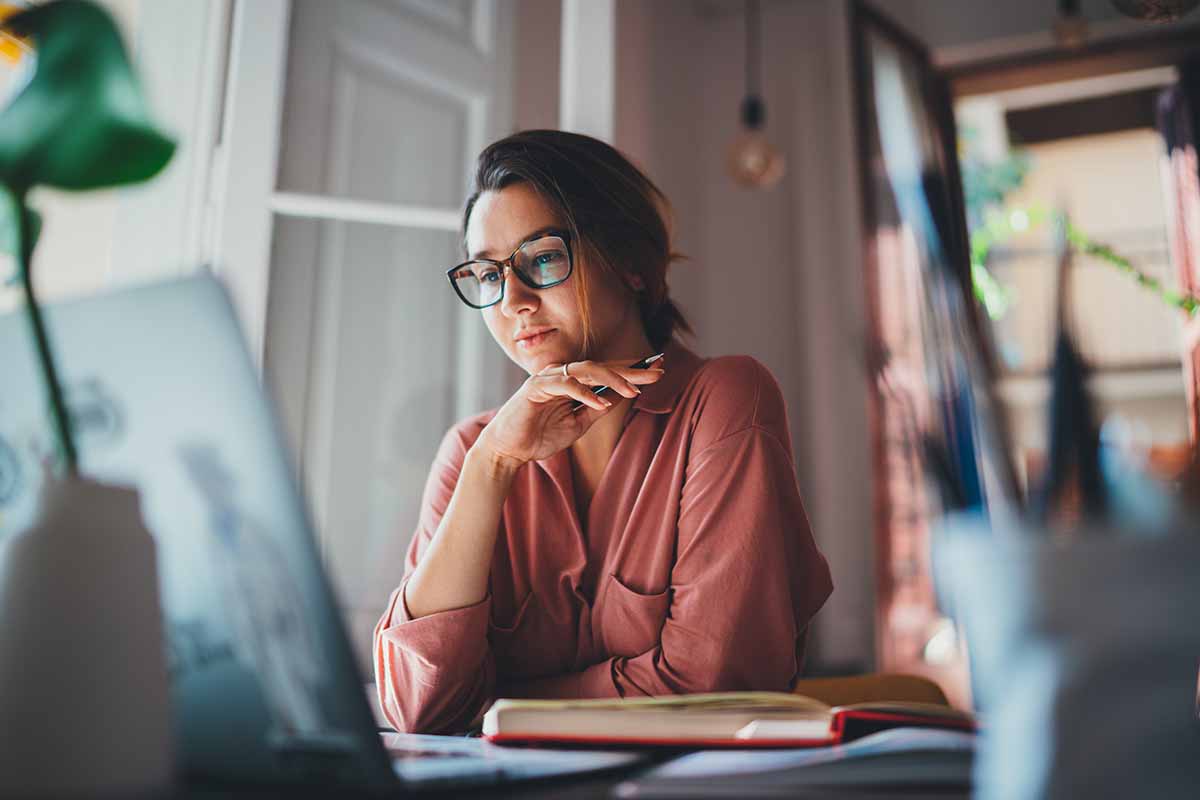 business woman sitting at table opposite laptop in work