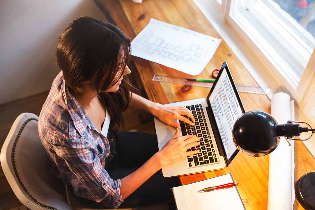 Young female blogger working at home