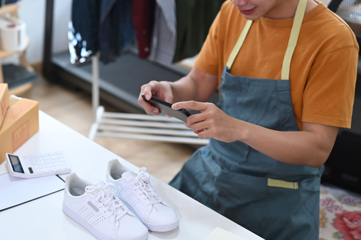 a business owner taking a picture of their product