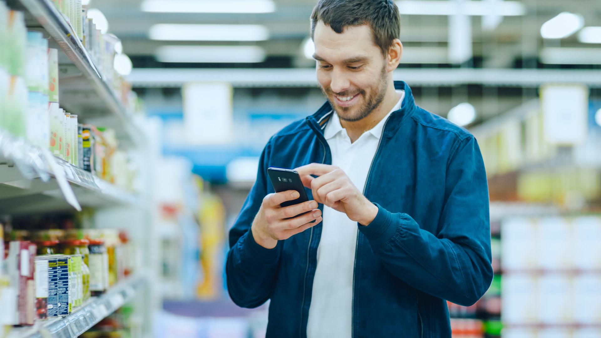 Man Uses Smartphone, Smiles