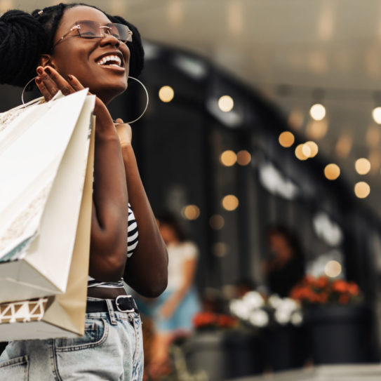 woman, in the mall with shopping bags, happy