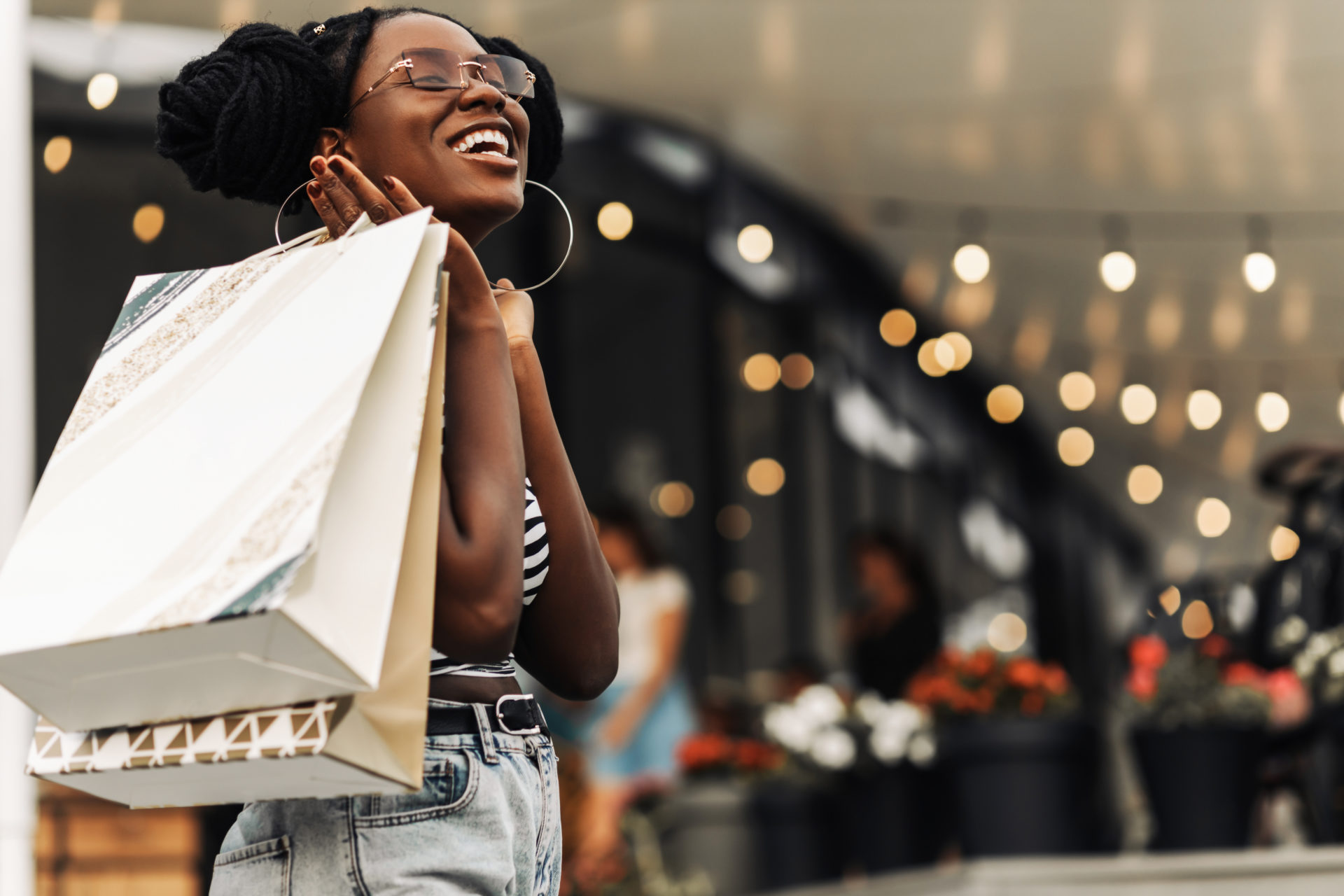 woman, in the mall with shopping bags, happy