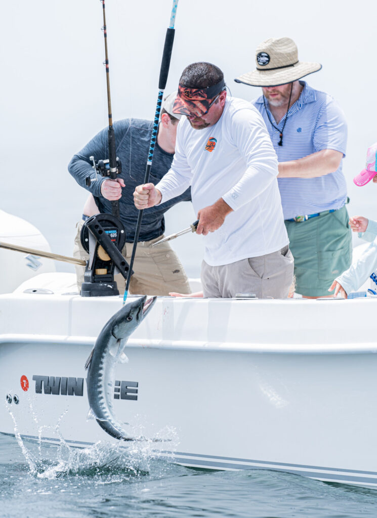 three men catching a fish