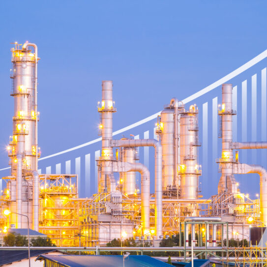 Oil refinery at twilight with sky background.