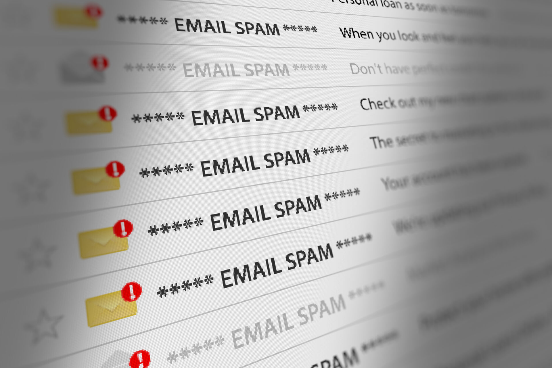 A close-up image of an email inbox. Most of the messages in the inbox are flagged as spam with red caution icons.