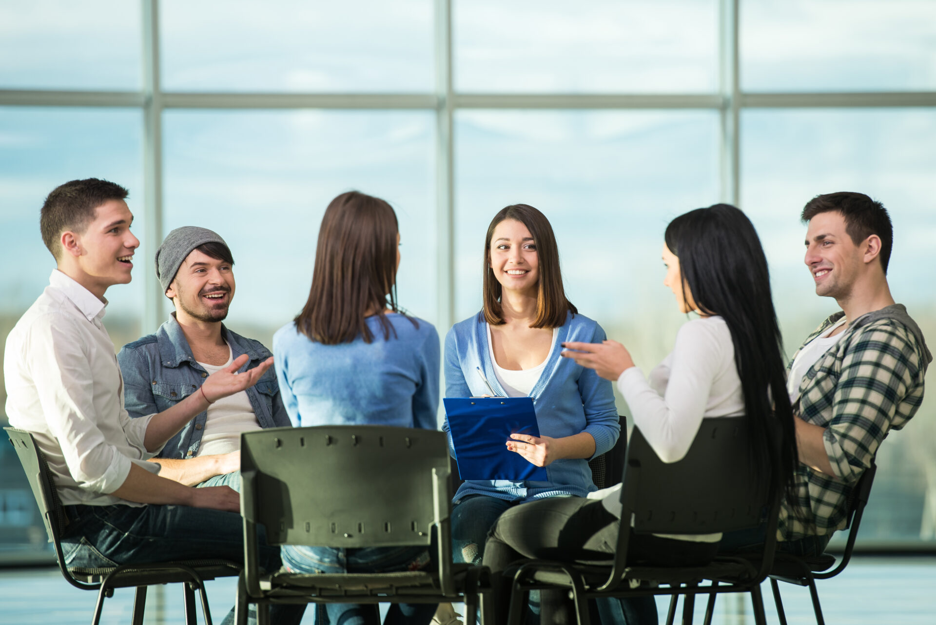 Circle of trust. Group of people are sitting in circle and supporting each other.