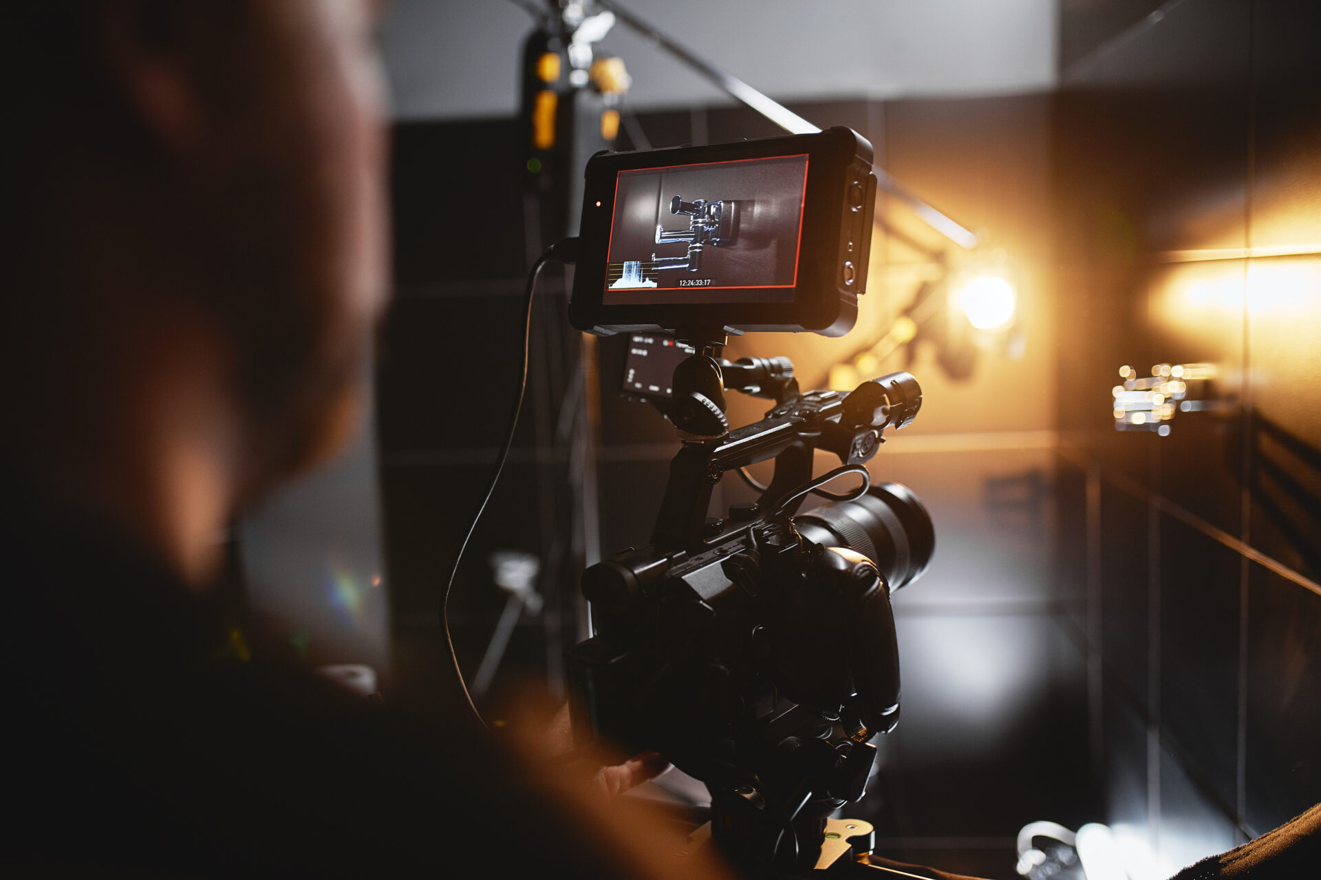 Video production backstage. Behind the scenes of creating video content, a professional team of cameramen with a director filming commercial ads. Video content creation, video creation industry, Low key, selective focus, film graine.