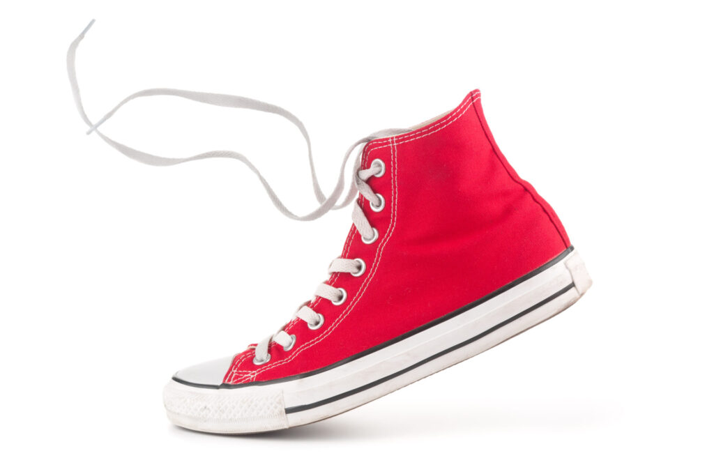 Single red sneaker on white background