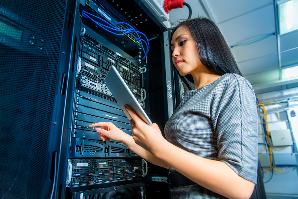 a young female IT professional works on a web server