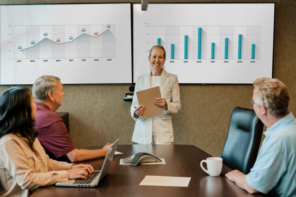 A Nichols Cauley & Associates team member giving a presentation to a client in a conference room.