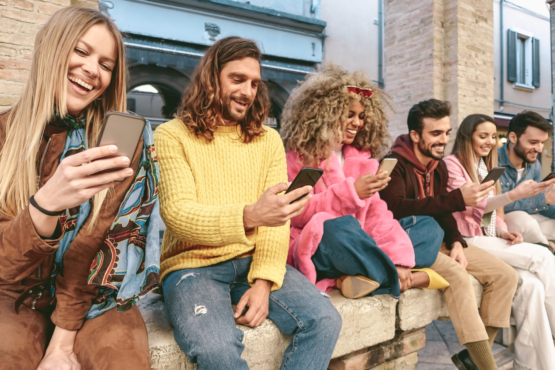 Group of friends using mobile smartphones outdoors 