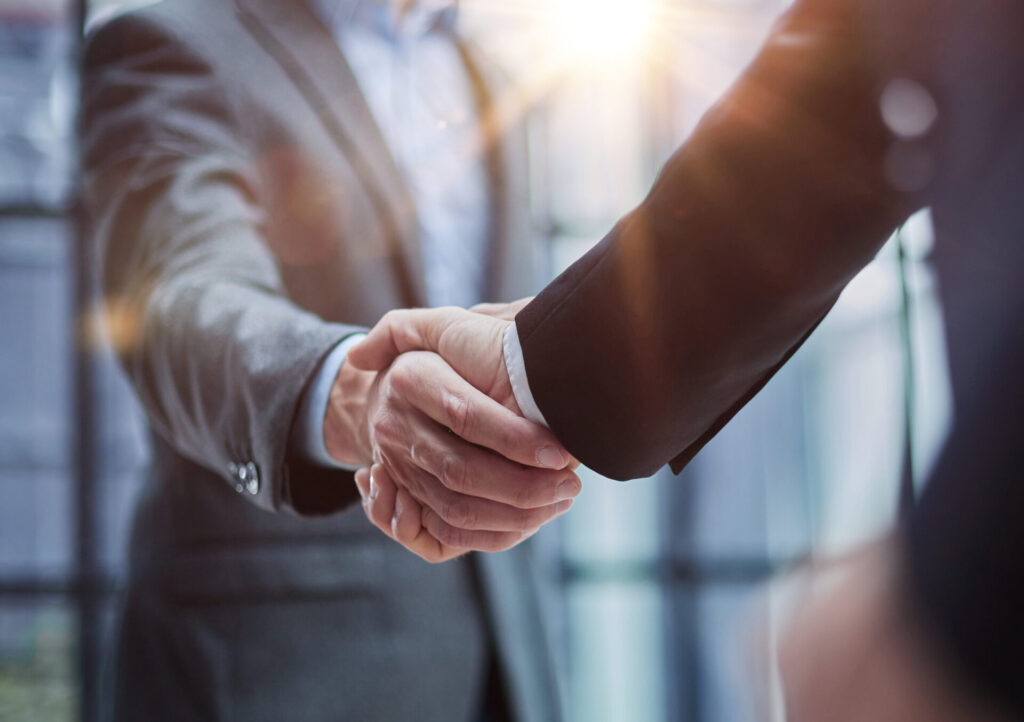 Two professional men shaking hands in an office