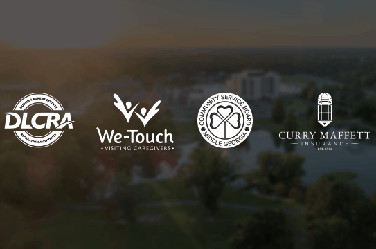 Four business logos—DLCRA, We-Touch Visiting Caregivers, Community Service Board Middle Georgia, and Curry Maffett Insurance—appear in white on a blurred park background with water and trees.