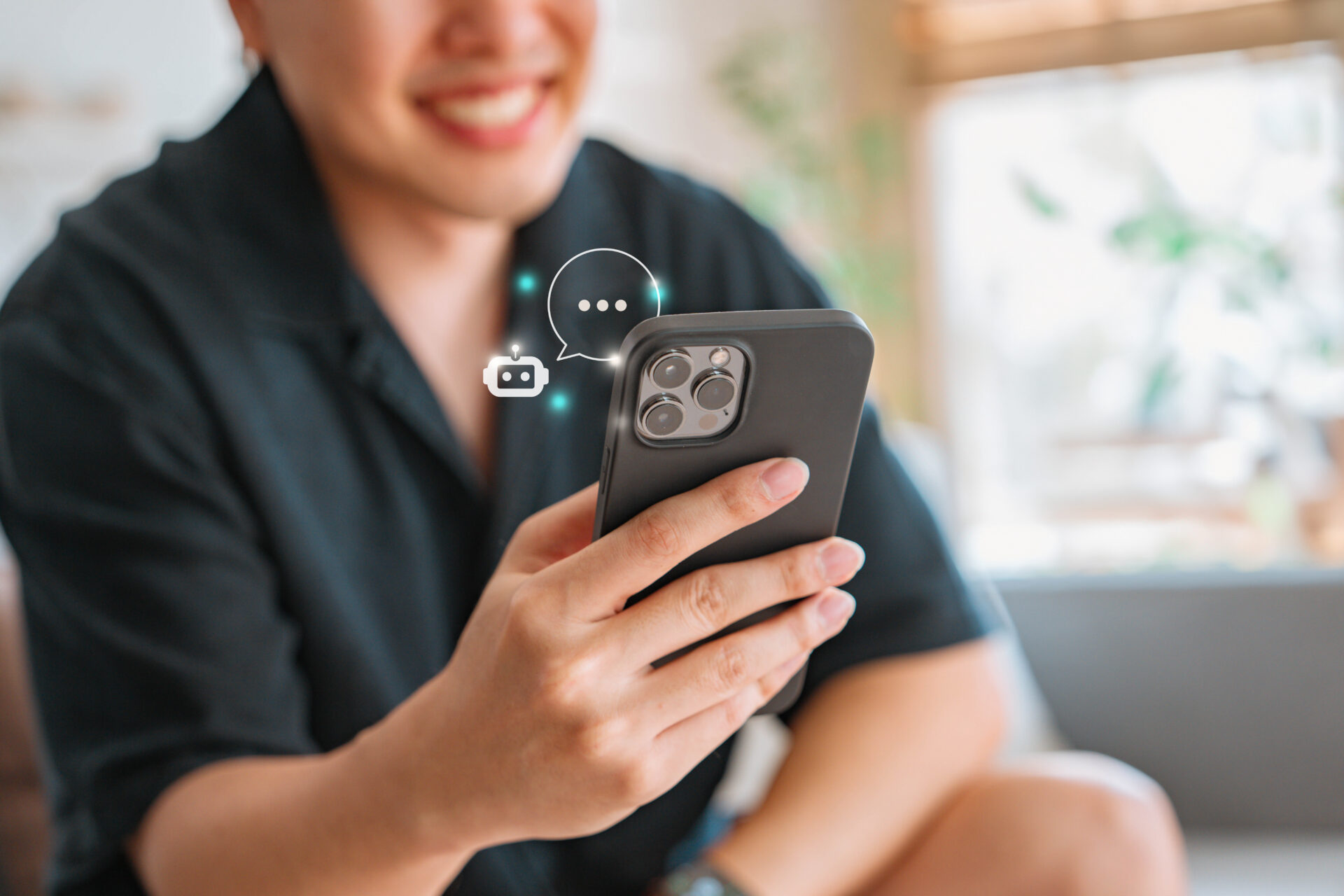 A smiling person holds a smartphone with chat and camera icons floating above it, suggesting social media. Softly blurred background.
