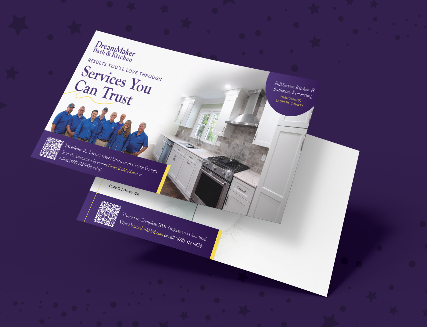Promotional postcard for DreamMaker Bath & Kitchen with staff group left, modern white kitchen right, and remodeling service details.